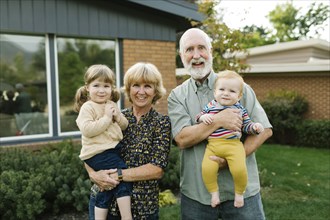 Portrait of smiling grandparents with grandchildren