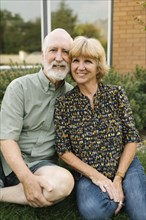 Portrait of smiling senior couple in backyard