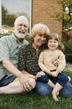 Portrait of smiling grandparents with granddaughter