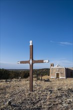 San Francisco de Asis Church with old wooden cross in foreground