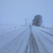 Empty rural road covered with snow