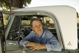 Senior woman in pick-up truck