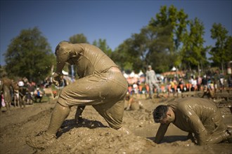 Sportsmen running in mud