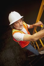 Worker descending ladder