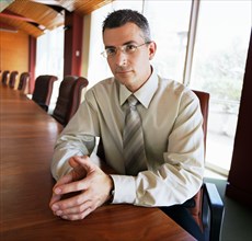 Portrait of businessman sitting in conference room