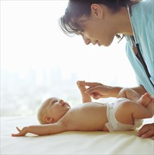 Doctor examining baby girl