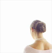 Rear view of woman wearing pearl necklace