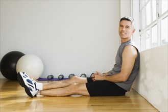 Portrait of man sitting in gym