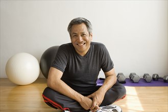 Portrait of man sitting in fitness studio