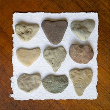 Collection of heart shaped stones on paper