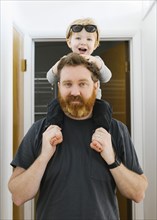 Portrait of father carrying son