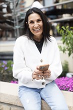 Portrait of smiling woman using phone