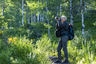 Senior man photographing while hiking in Sun Valley