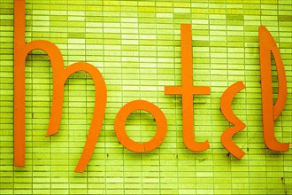 Vintage motel sign on green wall