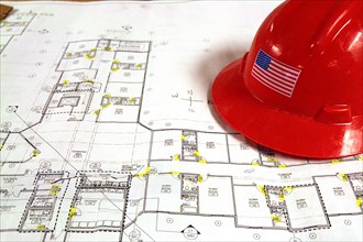 Blueprints and helmet for construction project