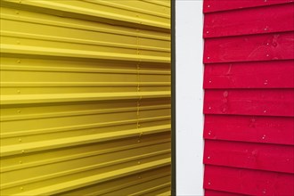 Close-up of yellow and red building walls