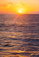 Ocean surface reflecting sunlight at sunrise