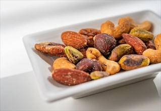 Close-up of small dish of assorted nuts on table