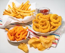 Assorted fattening processed foods on tablecloth