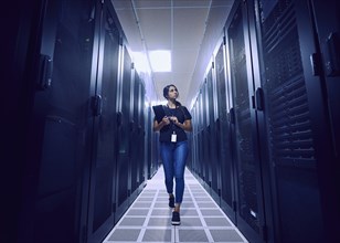 Female technician walking in server room