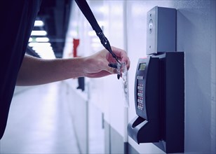 Close-up of employee using keycard and digital door lock in office