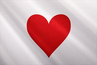 Red heart on white background with sunbeams