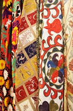 Variety of Suzani rugs at market