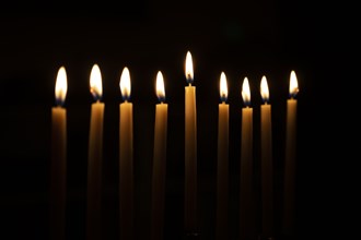 Row of candles against black background