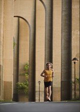 Man jogging under bridge