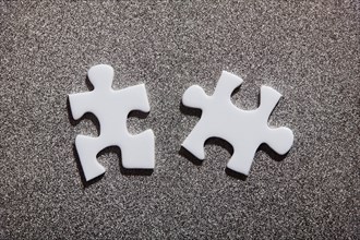 Two white jigsaw pieces