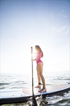 Woman paddleboarding on lake
