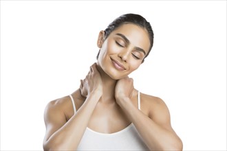 Portrait of young woman doing neck massage