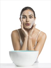 Portrait of young woman enjoying washing face