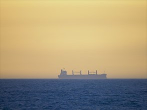 Container ship cruising on calm sea