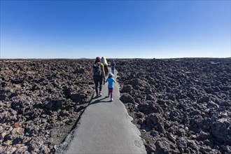 Family walking through lava field