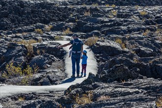 Father showing daughter lava field