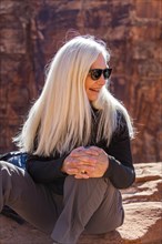 Smiling senior woman sitting in Zion National Park