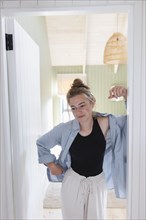 Teenage girl standing in doorway