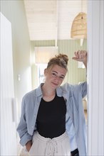 Portrait of teenage girl standing in doorway