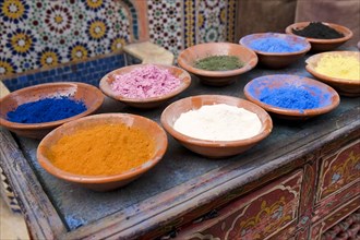 Traditional Moroccan clay bowls of colorful spices