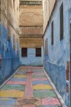Colorful blue walls in alleyway in medina