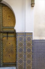 Traditionally decorated doors and tilework in medina
