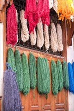 Colorful yarn hanging to dry after being dyed