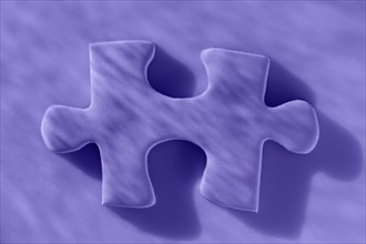 Studio shot of purple jigsaw piece