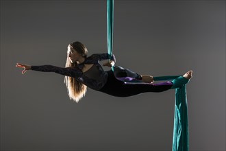 Teenage girl (14-15) practicing aerial silk