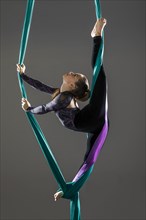 Teenage girl (14-15) practicing aerial silk