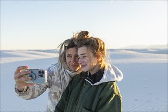 Mother and teen daughter taking selfie White Sands National Park