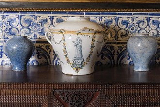 Antique Portuguese clay pots with blue tile background