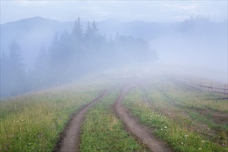 Foggy rural landscape in Carpathian Mountains