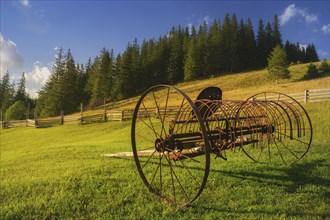 Old farm machine in rural landscape in Carpathian Mountains